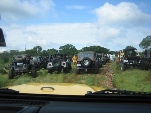 2001 Jeep Wrangler - A group of Jeep Wranglers are parked on a dirt road, ready for an off-road adventure.