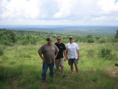 2001 Jeep Wrangler - Three men pose for a photo in a scenic outdoor location with rolling hills in the background.