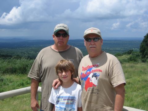 2001 Jeep Wrangler - Two men and a boy pose for a photo on a scenic overlook with a vast landscape in the background.