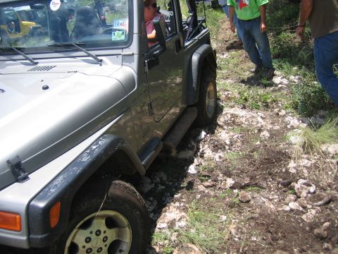 2001 Jeep Wrangler - A 2001 Jeep Wrangler drives off-road on a challenging trail with another vehicle behind it.