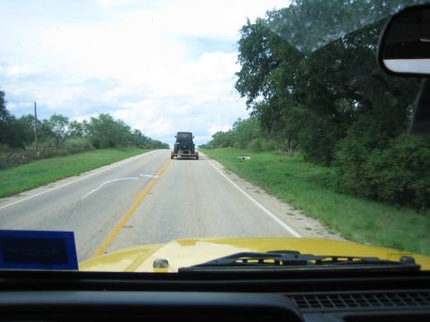 2001 Jeep Wrangler - View from a yellow Jeep Wrangler as it follows a towed Jeep Wrangler down a two-lane highway on a cloudy day.