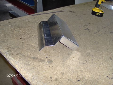 1978 Ford Bronco - Metal bracket on a workbench with a power drill in the background. Date stamp reads 07/24/2007.