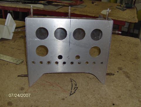 1978 Ford Bronco - This aluminum panel has multiple circular cutouts and rows of smaller holes, likely for instrumentation or controls.