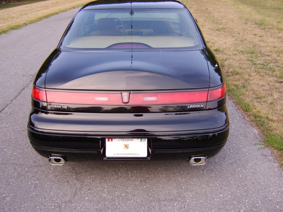 Black Lincoln Mark VIII coupe rear view with dual exhaust and Maryland plate