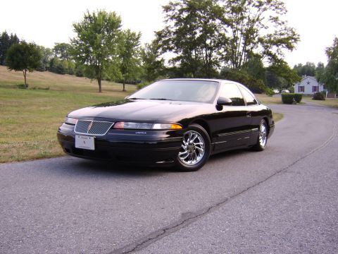 1996 Mercury Grand Marquis - This black Lincoln Mark VIII coupe features distinctive chrome wheels and a classic body style.