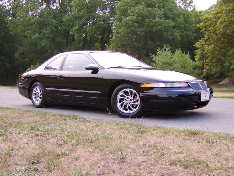 1996 Mercury Grand Marquis - This black coupe has a distinctive grille and chrome wheels, suggesting a mid-1990s model year.