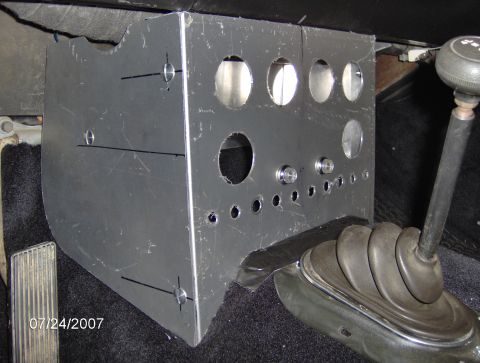 1978 Ford Bronco - A custom metal dashboard panel is installed in a vehicle's interior, with a gear shifter visible to the right.