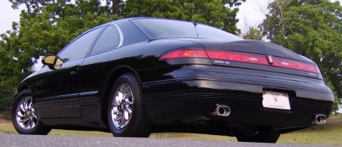 1996 Mercury Grand Marquis - Rear view of a black 1996 Lincoln Mark VIII, dual chrome exhaust tips and a distinctive taillight bar.