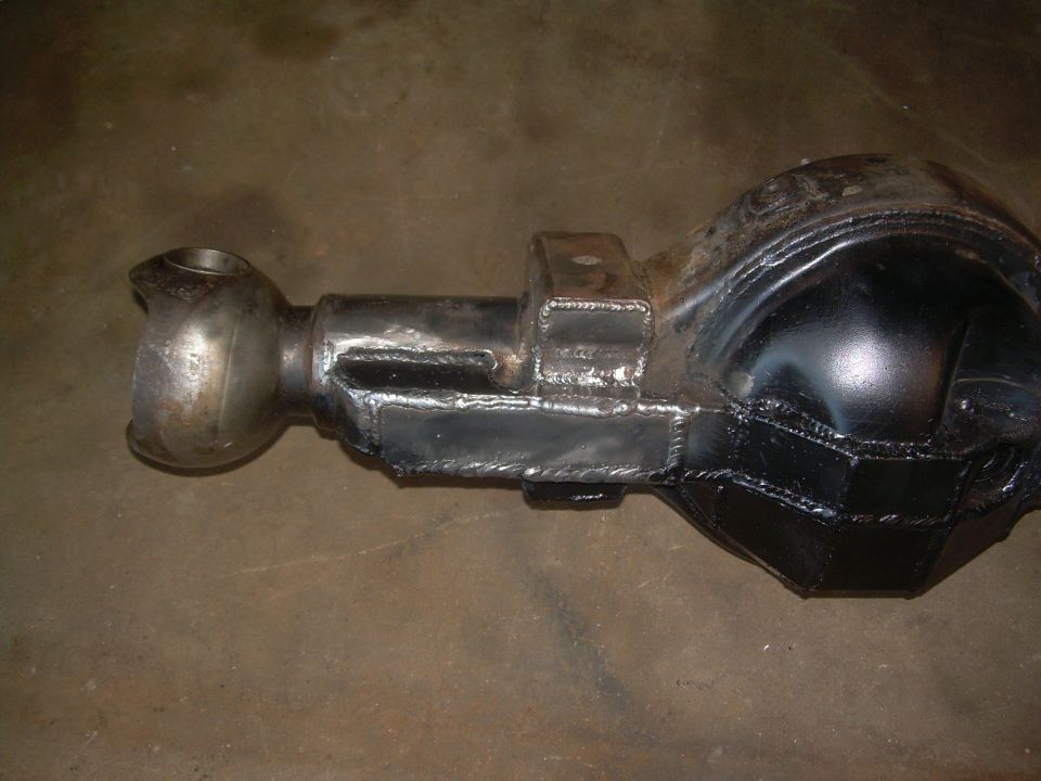 Modified rear axle housing with welded brackets and a U-joint yoke