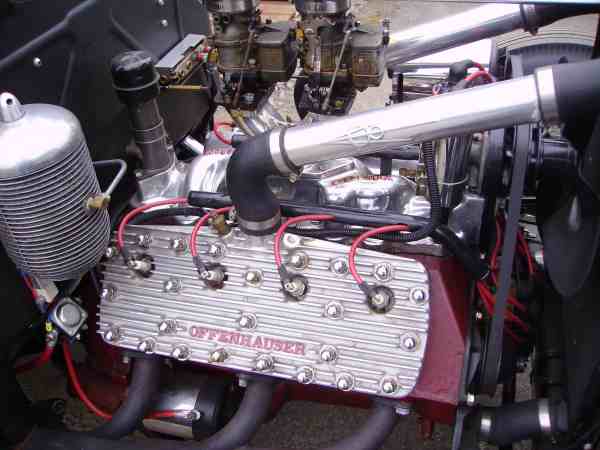 Close-up of a V8 engine with Offenhauser valve covers and dual carburetors
