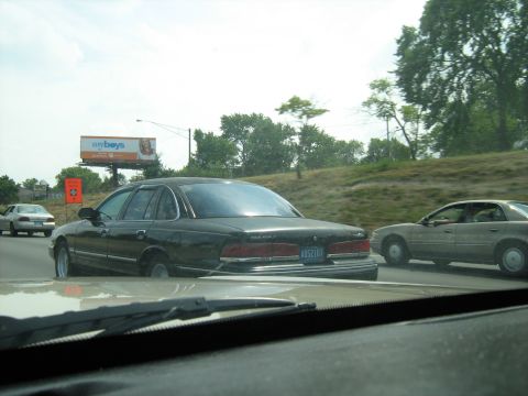 1988 Mercury Grand Marquis - Driving on the highway behind a black sedan, with another car visible to the right.