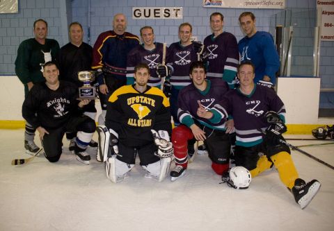 1985 Ford LTD Crown Victoria - A hockey team celebrates with a trophy after a game.