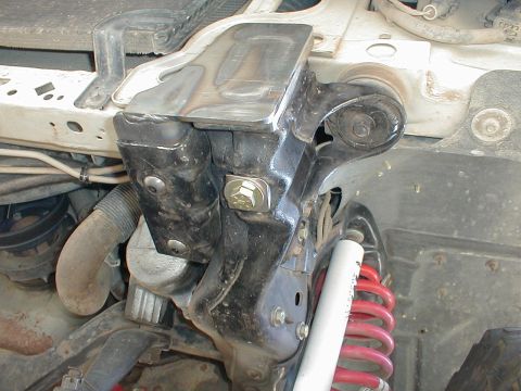 1996 Ford Bronco - Close-up of a custom front bumper mounting bracket and suspension components.