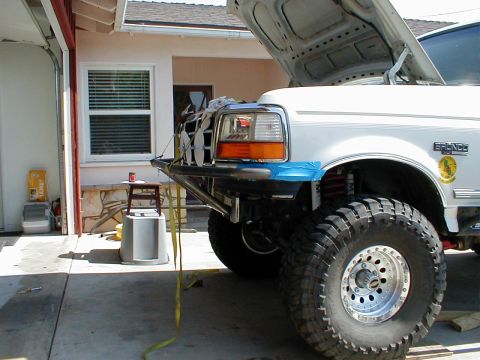 1996 Ford Bronco - Custom front bumper installed on a white Ford Bronco with the hood open.