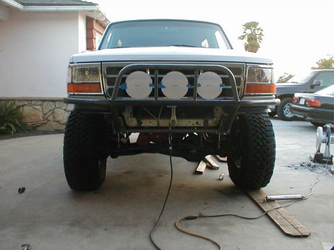 1996 Ford Bronco - Front view of a 1996 Ford Bronco modified with a custom bumper and lights, parked outdoors.