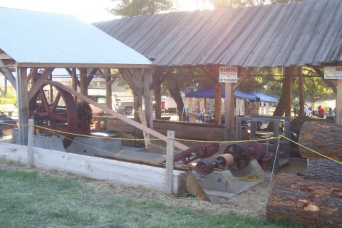 1994 Ford F-150 - Outdoor display of vintage industrial equipment, possibly at a fair or historical site.