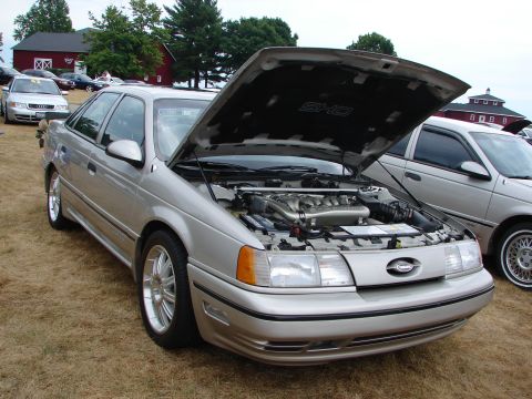 1993 Ford Taurus - A silver 1992 Ford Taurus SHO is displayed with its hood open at an outdoor car show.