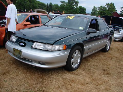 1993 Ford Taurus - This 1993 Ford Taurus SHO is displayed at an outdoor car show with other vehicles present.