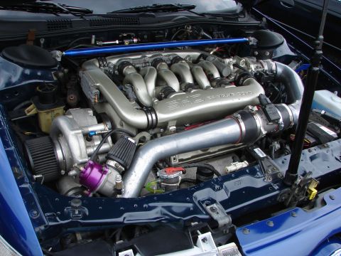 1993 Ford Taurus - Customized engine bay a turbocharger and SHO V8 engine cover, likely modified from its original configuration.