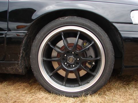 1993 Ford Taurus - Aftermarket wheel and tire assembly on a vehicle.