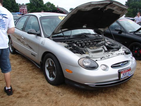 1993 Ford Taurus - Silver Ford Taurus SHO at a car show, hood open to reveal the V8 engine.