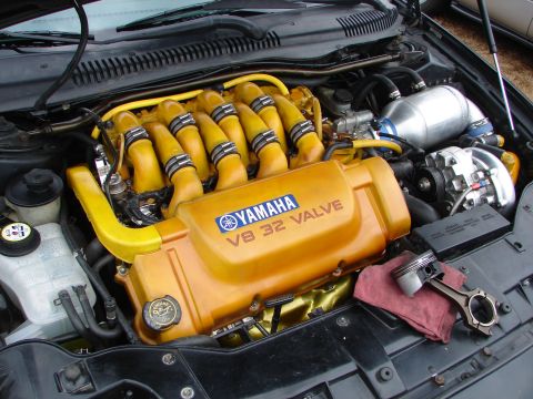 1993 Ford Taurus - Engine bay features a Yamaha V8 32 Valve engine cover and a detached piston resting on a cloth.