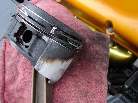 1993 Ford Taurus - This piston shows significant wear and damage, indicating a potential engine issue.