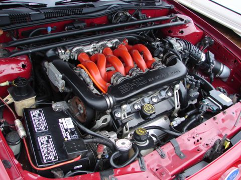 1993 Ford Taurus - Close-up of the 1993 Ford Taurus SHO engine, its distinctive red intake manifold and V6 24-valve DOHC configuration.
