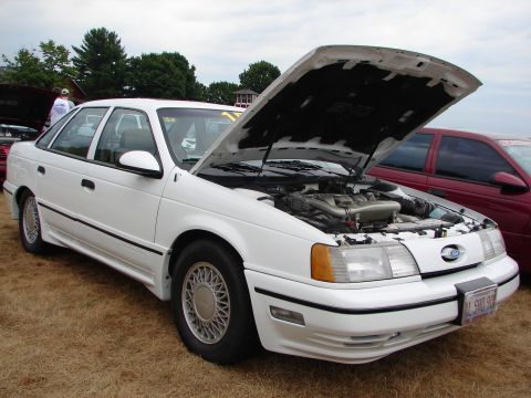1993 Ford Taurus - White 1993 Ford Taurus SHO at a car show, hood up to display the engine bay.