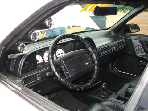 1993 Ford Taurus - Interior view of a 1993 Ford Taurus, aftermarket gauges mounted on the dashboard.