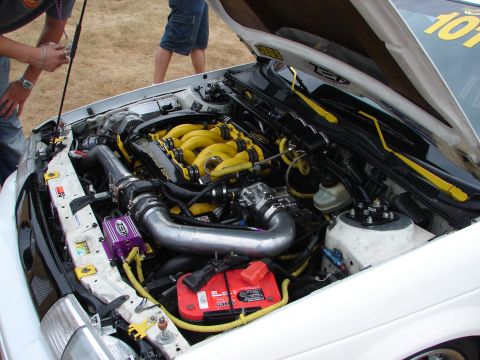 1993 Ford Taurus - Customized engine bay a yellow intake manifold and aftermarket components.