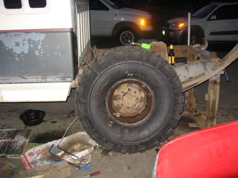 1990 Ford F-250 - A truck chassis is visible with a large tire, suggesting it is undergoing repairs or modifications.