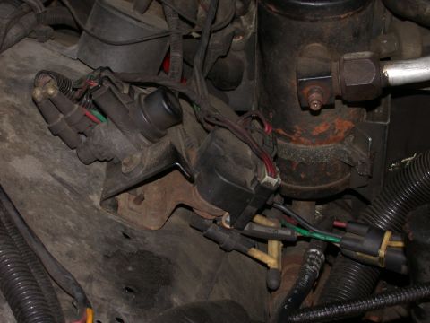 1987 Lincoln Town Car - Close-up view of engine bay components, including vacuum lines and electrical wiring.