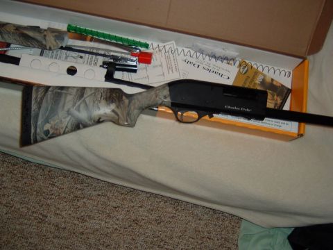 1986 Ford Bronco - A Charles Daly shotgun with a camouflage stock is shown inside its box with included accessories and documentation.