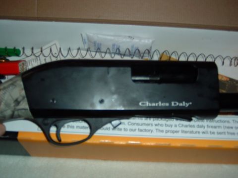 1986 Ford Bronco - Close-up of a Charles Daly shotgun receiver, showing text and internal components.