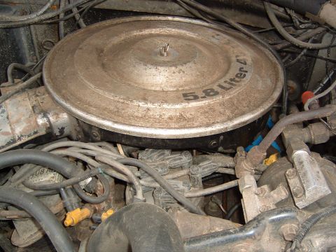 1986 Ford Bronco - Close-up of an engine bay, focusing on the air cleaner and associated engine parts.
