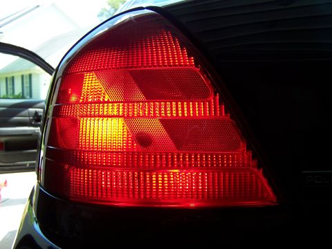 2003 Ford Crown Victoria - Rear taillight assembly of a car, showing the intricate pattern of the red lens.