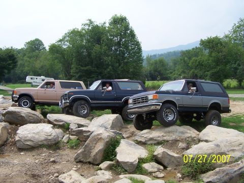 1979 Ford F-150 - Three Ford Broncos navigate a rocky trail, their off-road capabilities.