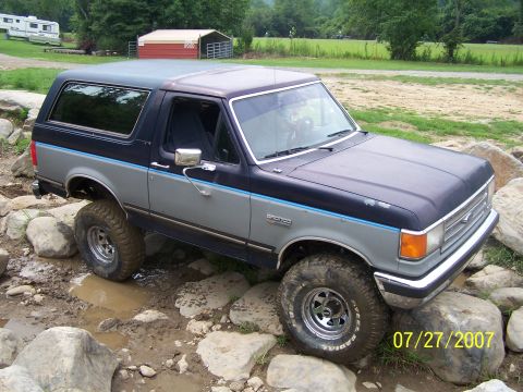 1979 Ford F-150 - Ford Bronco is shown off-roading over rocks and through mud.