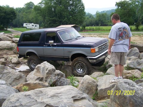 1979 Ford F-150 - Ford Bronco tackling a challenging rocky terrain on a summer day.