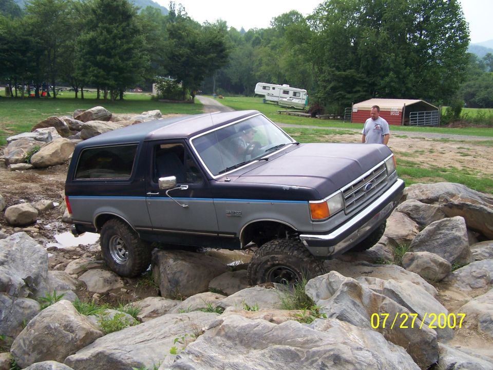 1987 Ford Bronco navigating a rocky obstacle course
