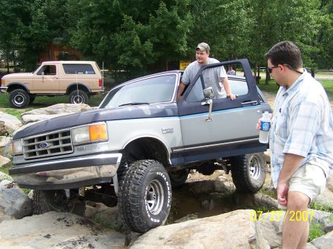 1979 Ford F-150 - Two Ford Broncos navigate a rocky trail, their off-road capabilities.