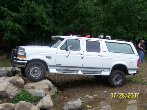 1979 Ford F-150 - White extended cab pickup truck with camper shell navigating rocky terrain. Date stamp is 07/28/2007.