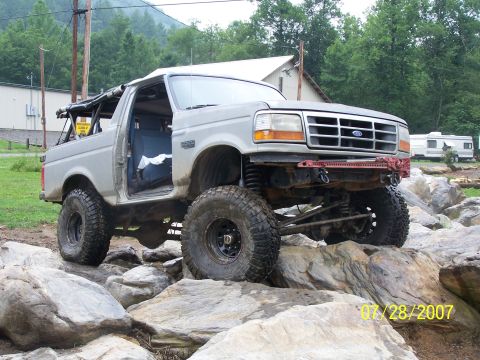 1979 Ford F-150 - This lifted SUV navigates a rocky terrain, its off-road capabilities and a visible date stamp of 07/28/2007.