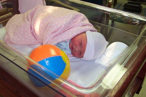 1966 Ford Galaxie - A baby rests in a bassinet, swaddled in a pink blanket next to a beach ball.