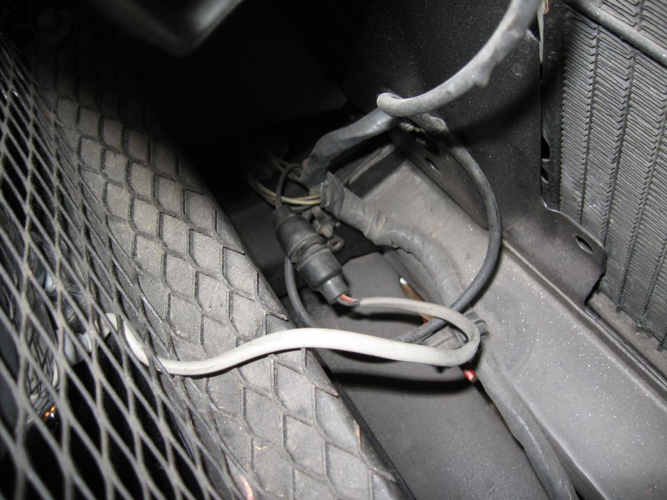close-up of car wiring harness and radiator grille