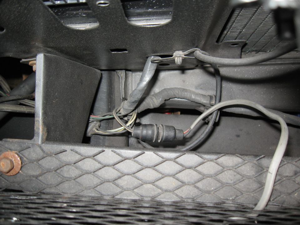 Close-up of a vehicle's wiring harness and connector