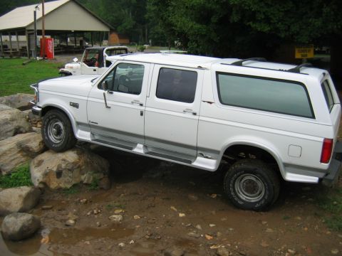 1992 Ford Mustang - This extended cab SUV appears to be from the early to mid-1990s, possibly a Ford Bronco or similar model, shown off-road.