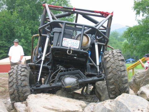 1992 Ford Mustang - Custom buggy with extreme suspension and large off-road tires on a challenging rock course.