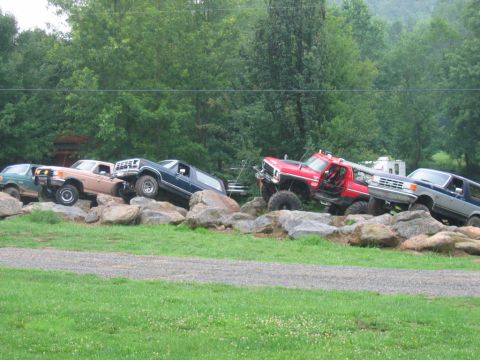 1992 Ford Mustang - Multiple off-road vehicles navigate a challenging rocky terrain, their capabilities.